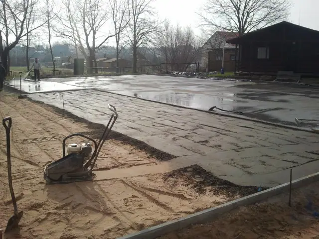Zacieranie mechaniczne świeżo wylanej betonowej płyty pod boisko w Sianożętach