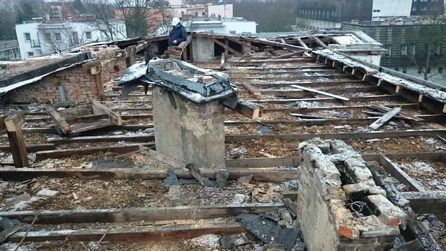 Odkryta więźba dachowa budynku po zdjęciu pokrycia, widoczny komin z cegły