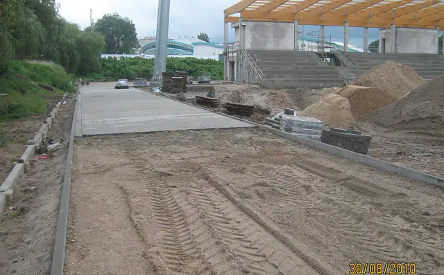 Świeża nawierzchnia betonowa przed trybunami stadionu w trakcie budowy